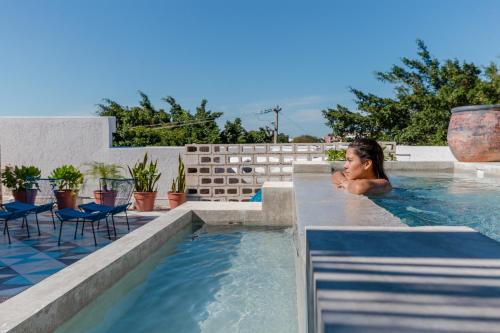 a woman in a swimming pool at a resort at Studios Downtown Cancun in Cancún