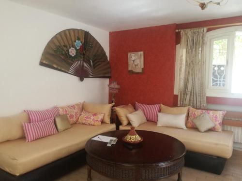a living room with a couch and a table at Miramar in El Harhoura