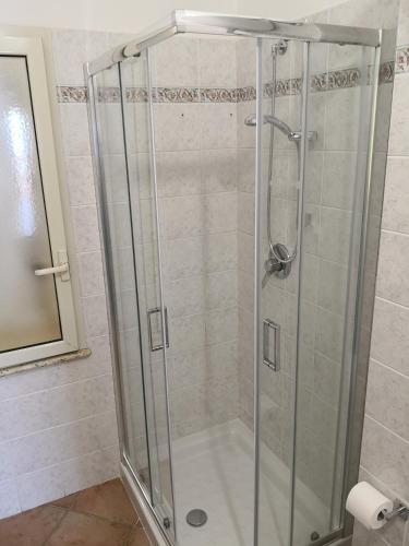 a shower with a glass door in a bathroom at Holiday Beach Lumia in Sciacca