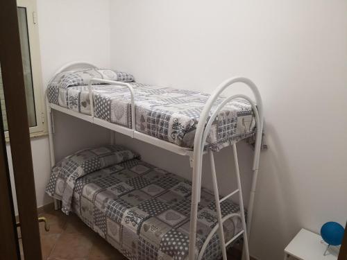 two bunk beds in a room next to a wall at Holiday Beach Lumia in Sciacca