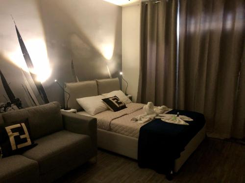 a bedroom with a bed and a couch at Nautilus Boutique Townhouse in Sliema