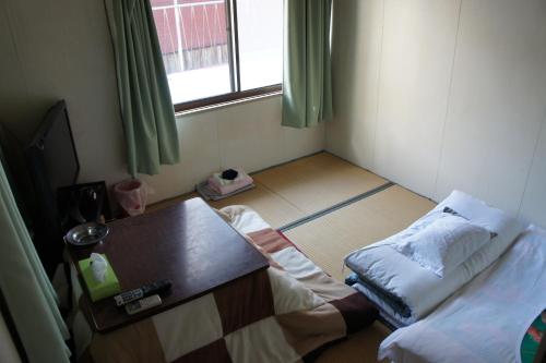 Cama o camas de una habitación en Miyoshiya Ryokan