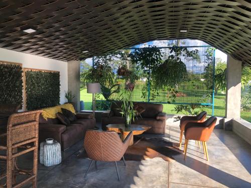 a living room with a couch and chairs at Finca Hotel Brasilia in La Tebaida
