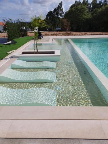 a swimming pool with water in the middle at PÉROLA D'ÓBIDOS t1 in Óbidos