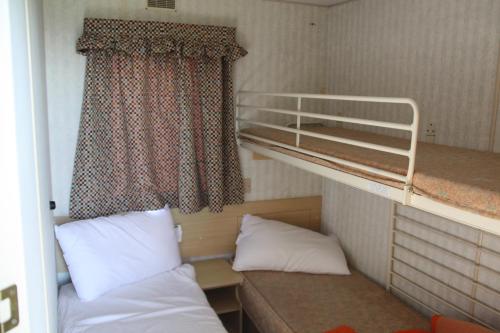 a small room with two bunk beds and a window at lathuillere in La Motte-Saint-Jean