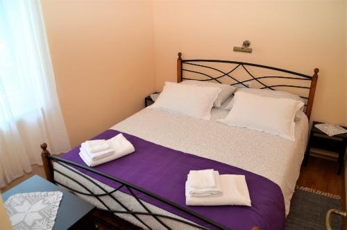 a bedroom with a bed with white towels on it at Apartment Renata in Lovran