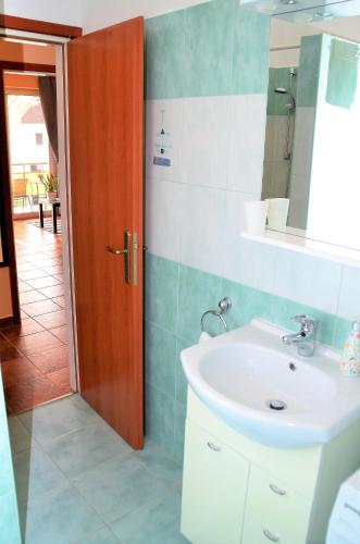 a bathroom with a sink and a mirror at Apartment Renata in Lovran