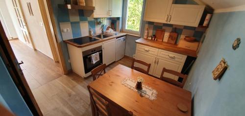 an overhead view of a kitchen with a wooden table at Tree in Bled