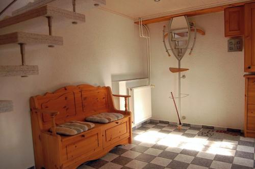 a bedroom with a wooden bed in a room at Ferienwohnung Sonne & Sauna in Sönnebüll
