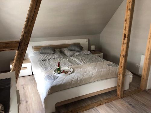 a bedroom with a bed with a bottle of wine on it at Fewo-Am-Hahnenberg in Goslar