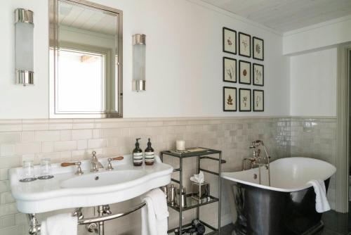 a white bathroom with a tub and a sink at Eleven Scarp Ridge Lodge in Crested Butte