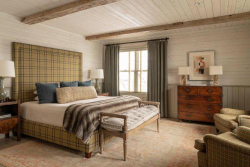 a bedroom with a bed and a chair and a couch at Eleven Scarp Ridge Lodge in Crested Butte