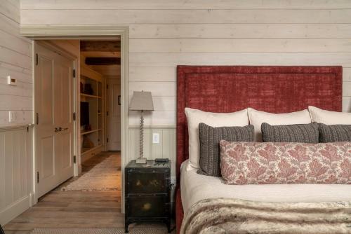 a bed with a red headboard in a bedroom at Eleven Scarp Ridge Lodge in Crested Butte