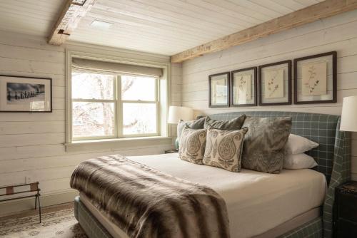 a bedroom with a bed with pillows and a window at Eleven Scarp Ridge Lodge in Crested Butte