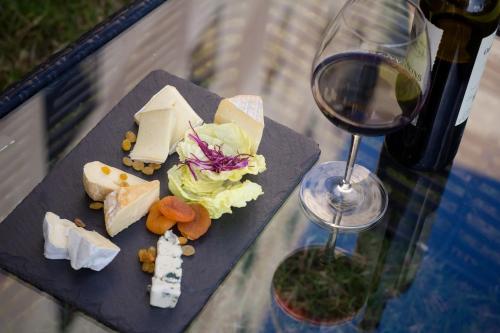 a plate of cheese and a glass of wine at Sofitel Algiers Hamma Garden in Alger