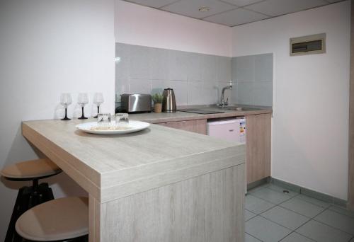 a kitchen with a counter with a plate on it at Pier Beach Hotel Apartments in Limassol