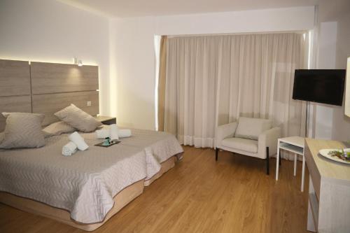 a hotel room with a bed and a chair at Pier Beach Hotel Apartments in Limassol