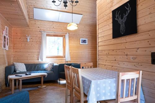 a living room with a table and a couch at Waldhaus Hilde in Suderburg