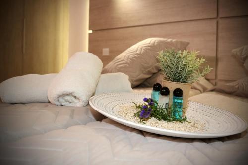 a plate with three bottles of wine on a bed at Pier Beach Hotel Apartments in Limassol