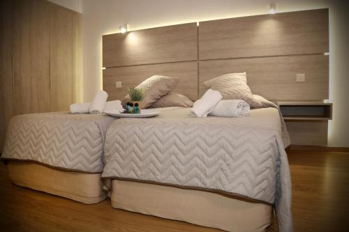 a bedroom with a large bed with a large headboard at Pier Beach Hotel Apartments in Limassol