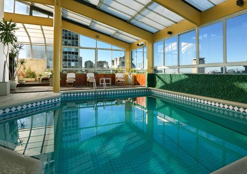 a swimming pool in the middle of a building at Hotel Dolmen in Buenos Aires