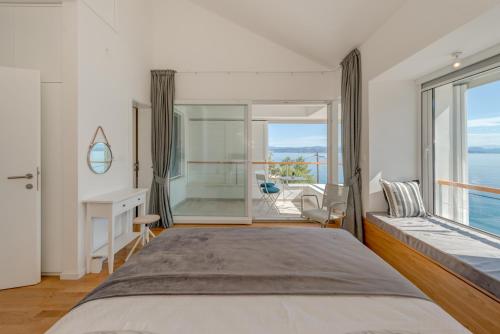 a bedroom with a bed and a desk and a window at Villa Talia in Donje Selo na Šolti