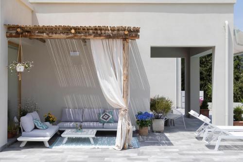 a patio with a purple couch and a canopy at La Suite con Piscina Privata in Portoferraio