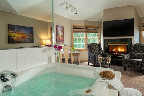 a large bathroom with a tub with a fireplace at Ashbrooke Hotel in Egg Harbor
