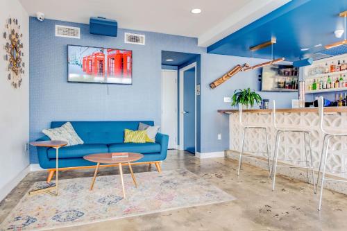 a living room with a blue couch and a bar at Downtowner Boutique Hotel in Las Vegas
