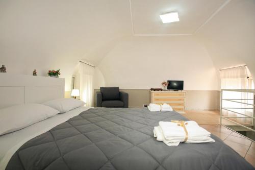 a bedroom with a large bed with towels on it at Rifugio del Marchese in Ercolano