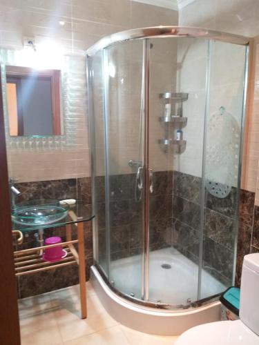 a shower with a glass door in a bathroom at La belle vue Marina golf in Asilah