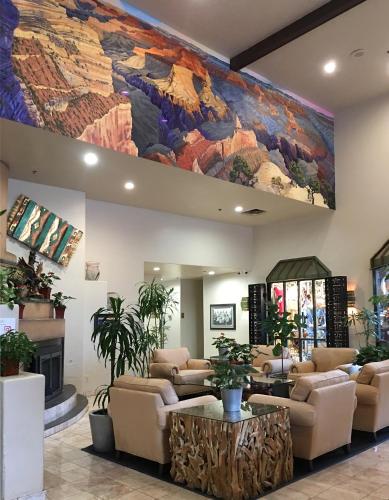 a lobby with a large painting on the wall at Grand Canyon Plaza Hotel-South Rim in Tusayan