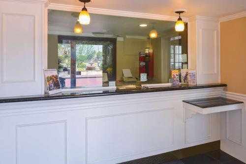 a counter with a large mirror in a room at Laguna Inn and Suites in San Juan Capistrano
