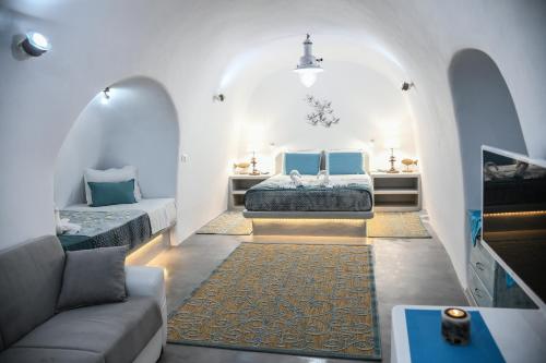 a living room with two beds and a couch at Serenity Blue (Cave house) in Akrotiri