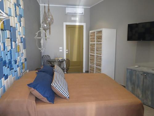 a bedroom with a bed with blue and white pillows at Catria in Favignana