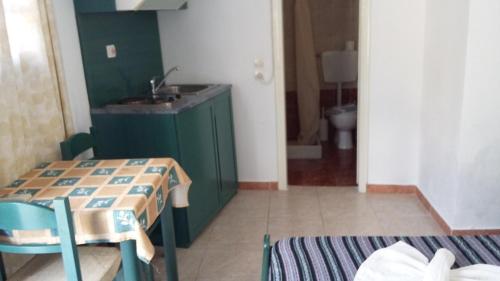 a kitchen with a table and a sink and a bathroom at 5bedroom villa in perissa beach in Perissa