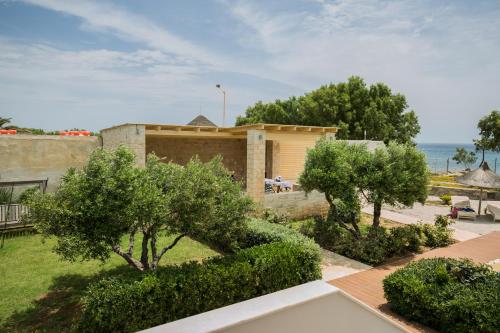 a view of a house with bushes and trees at Villa Pelagos in Koutsounari