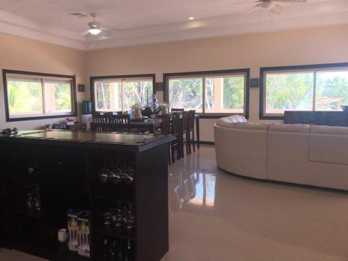a living room with a couch and a bar at Seaside Chateau Resort in Belize City