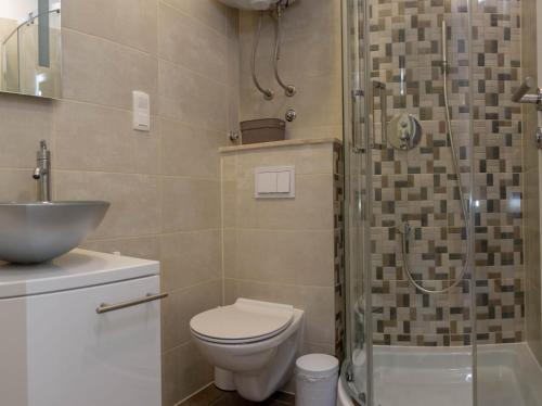 a bathroom with a toilet and a sink and a shower at Casteletti in Kaštela