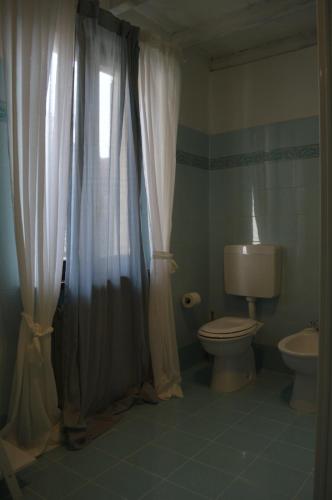 a bathroom with a toilet and a sink and a window at B&B Casa Rachele in Pianello Val Tidone