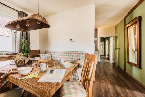 a dining room with a wooden table and a couch at Ferienwohnung HarzReise in Braunlage