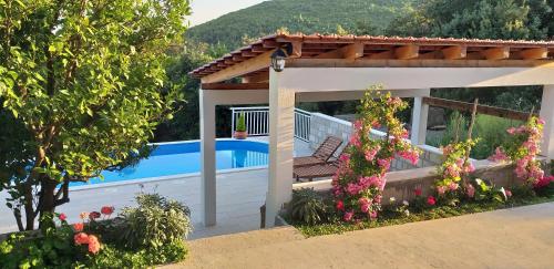a villa with a swimming pool and a house at Mediterranean stone house in Babino Polje