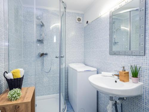 a bathroom with a toilet and a sink and a shower at Casa Montana Apartments in Balatonalmádi