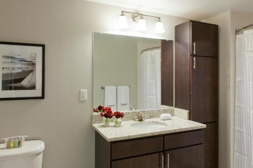 a bathroom with a sink and a mirror at Furnished Quarters at 15/25 Bank Street in White Plains