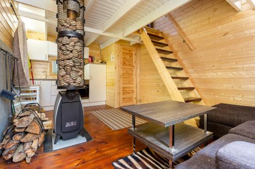 a living room with a wood stove in a cabin at Ainja Puhkemaja in Viljandi