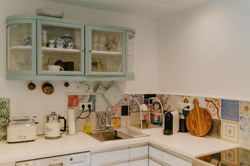 a kitchen with green cabinets and a counter top at Lieblings Platz hytte in Kirburg