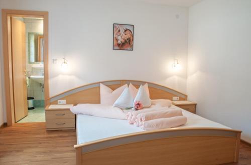 a bedroom with a bed with towels on it at Haus Lärchenwald in Niederthai