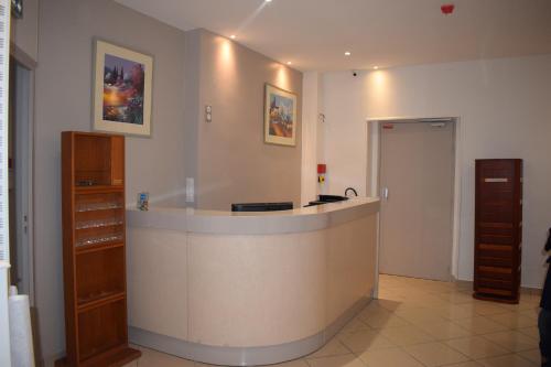 a lobby with a reception desk in a building at Hotel Puy De Dôme in Paris