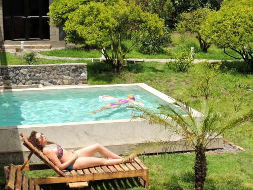 two women laying in a chair in a swimming pool at La Casta in Patate