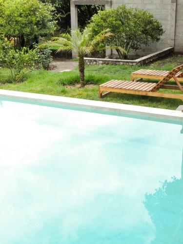 a swimming pool with a bench and a picnic table at La Casta in Patate